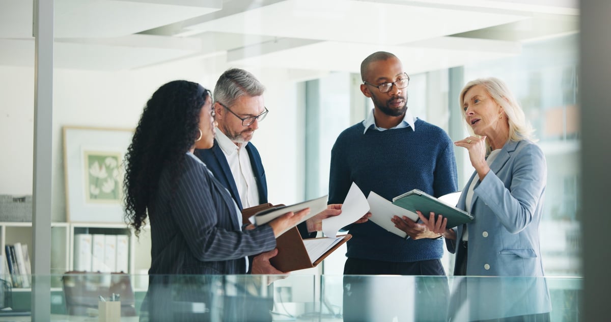 Professional accountants and financial managers in a modern corporate office discussing finance strategy — representing the analytical, detail-oriented experience of Islamic car finance tailored for accountants and finance professionals in Australia